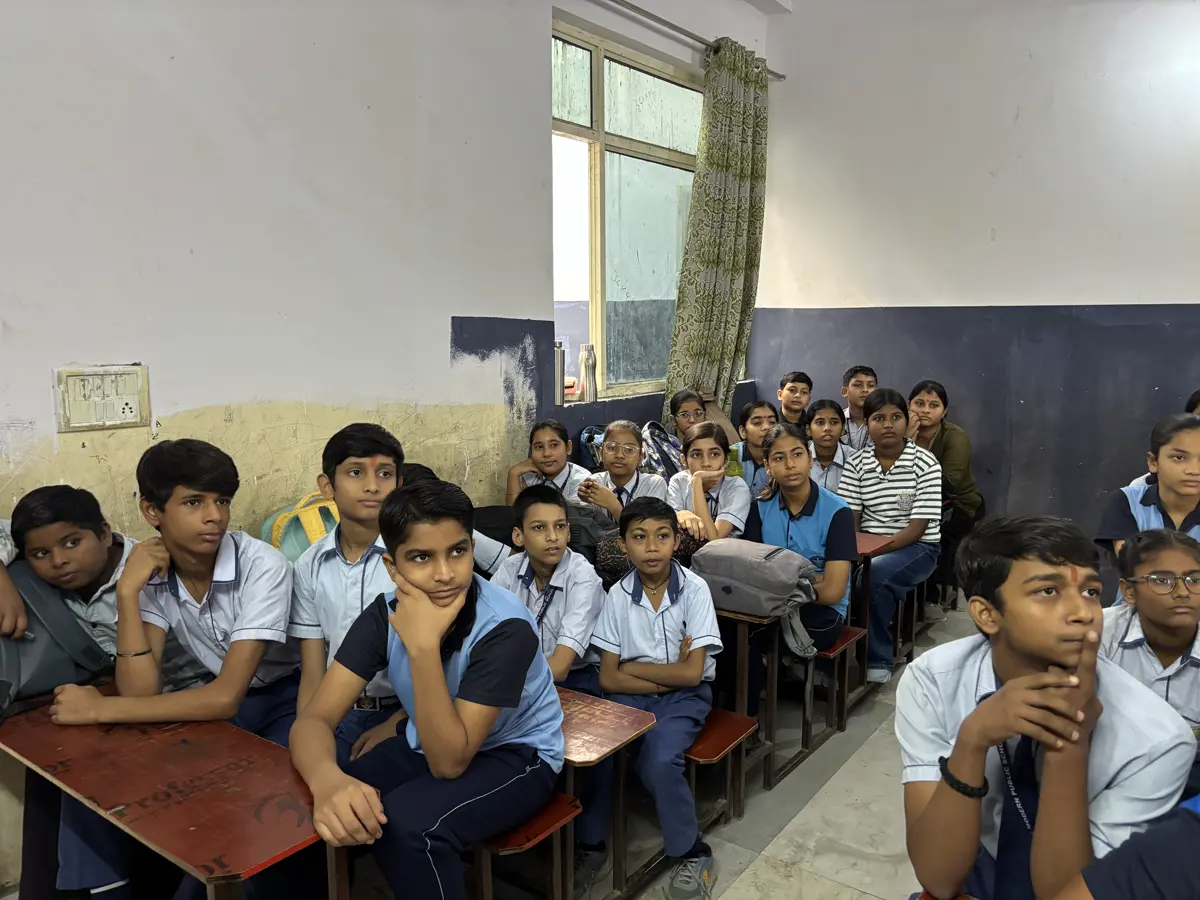 Students in school uniform listening during a StuTem robotics session