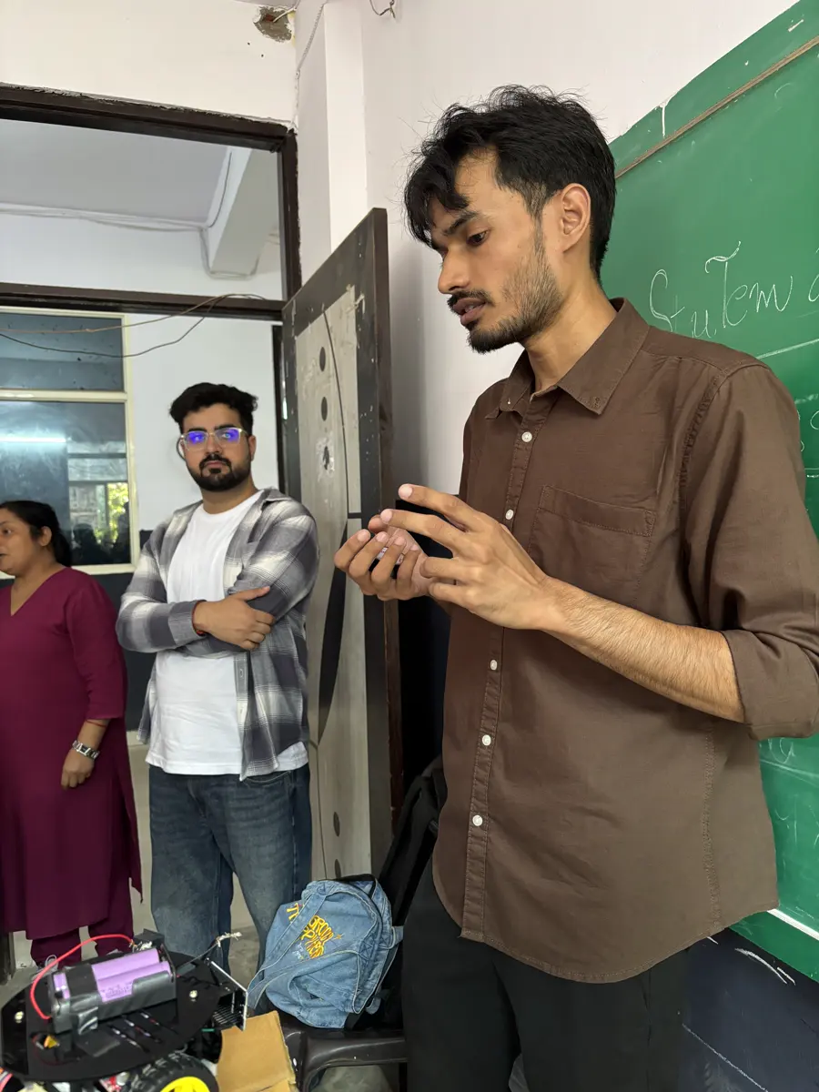 StuTem mentor explaining a hardware build at the front of the classroom