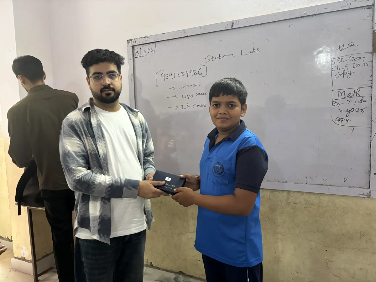 Student receiving a StuTem kit from a mentor